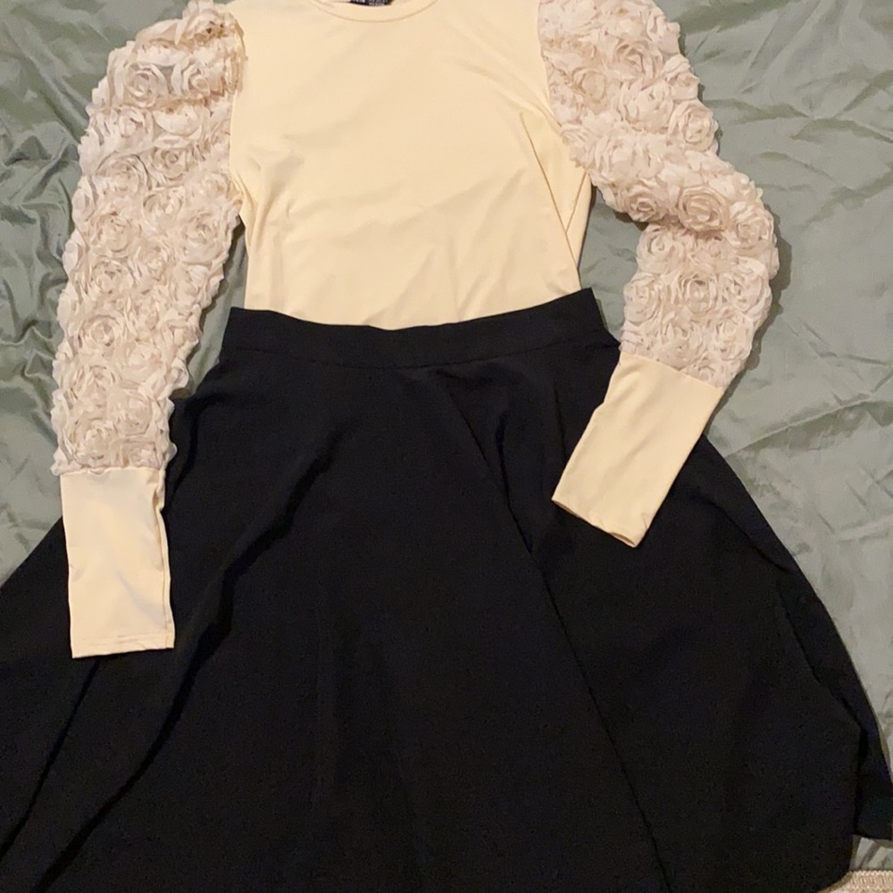 Black full skirt and cream bodysuit